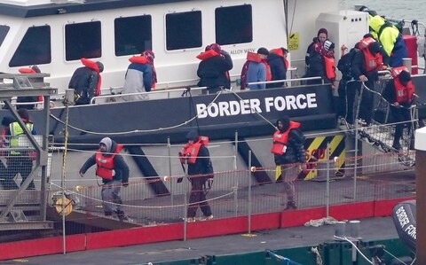 A group of migrants from a small boat in the Channel are landed at Dover by Border Force 