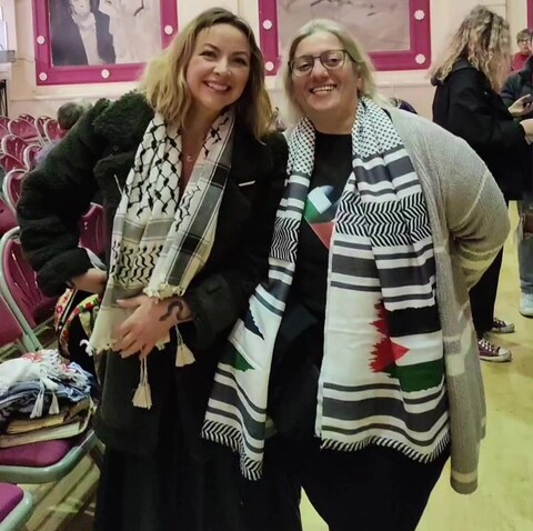 Charlotte Church (left) smiles with an activist at the singing event