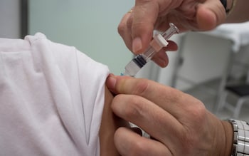 Nurse vaccinating little girl at Healthcare Center. Whooping cough, diphtheria and tetanus