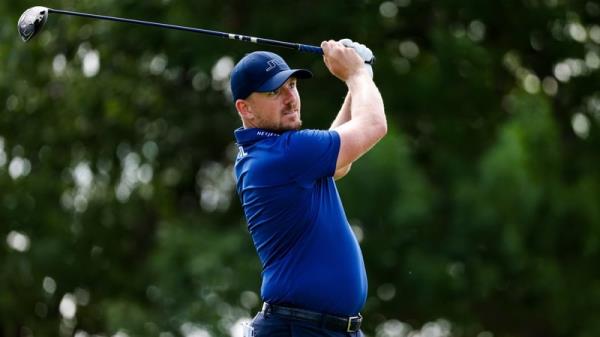 Matt Wallace plays his tee shot on the 11th hole