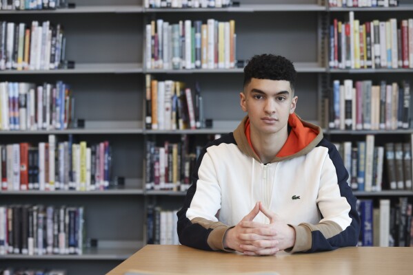 Max Decker, a senior at Lincoln High School, sits for a portrait in the school library wher<em></em>e he often worked on writing his college essays, in Portland, Ore., Wednesday, March 20, 2024. (AP Photo/Amanda Loman)