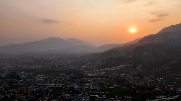 Drone shot of a low sun by the mountains near Kathmandu.