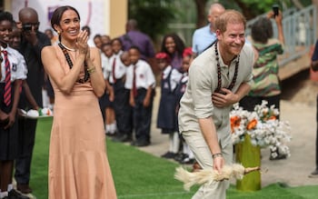 Britain's Prince Harry (R), Duke of Sussex, and Britain's Meghan (L), Duchess of Sussex, take part in activities as they arrive at the Lightway Academy in Abuja on May 10, 2024 as they visit Nigeria as part of celebrations of Invictus Games anniversary.