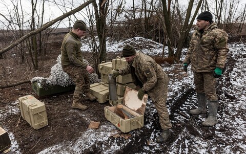 Ukrainian soldiers order ammunition boxes at their fighting position near Bakhmut, Do<em></em>netsk Oblast, Ukraine, on Tuesday