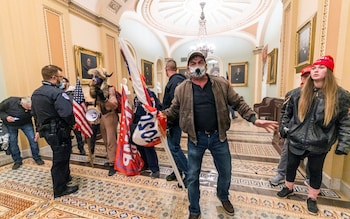 Supporters of Do<em></em>nald Trump are co<em></em>nfronted by capitol police officers on Jan 6 after storming the building