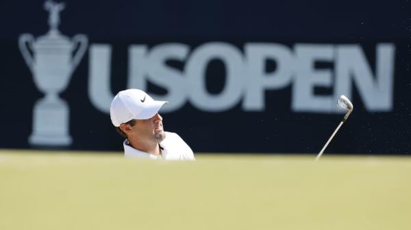 Scottie Scheffler chips o<em></em>nto the third green during a practice round on Wednesday