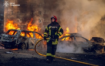 A firefighter works at the site of a Russian missile strike in Sumy, Ukraine