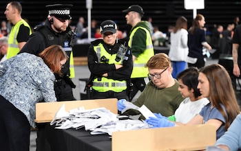 Police officers stand by at the count