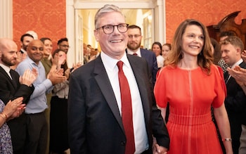 Sir Keir Starmer and his wife Victoria are clapped by staff as they enter No 10, on Friday