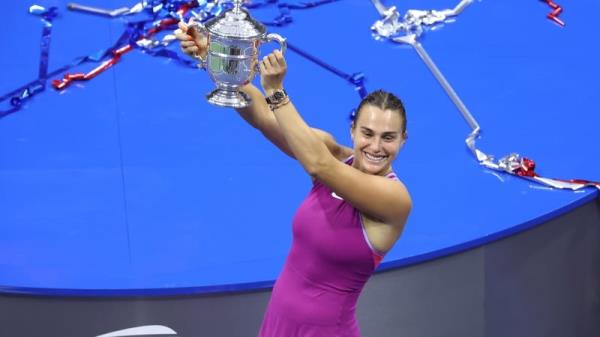 Aryna Sabalenka celebrates with the winners trophy