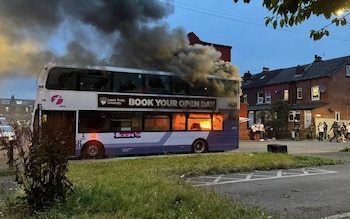 Rioters set a local bus alite during the chaos