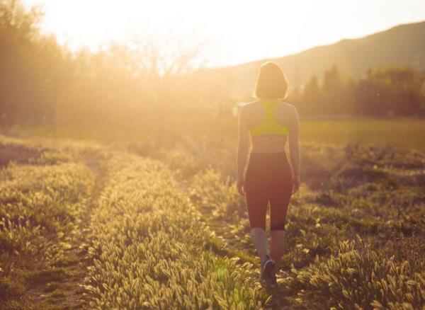 woman walking in the sunshine, co<em></em>ncept of how many steps to take to live longer