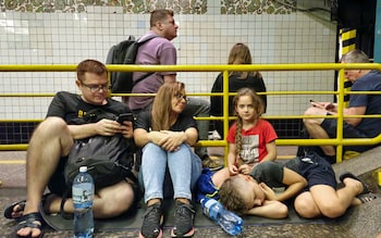 People take cover inside a metro station 