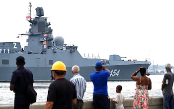 The frigate from the side, with Cuban lookers-on