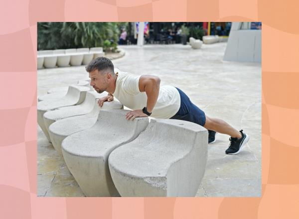 middle-aged man doing elevated pushups outdoors