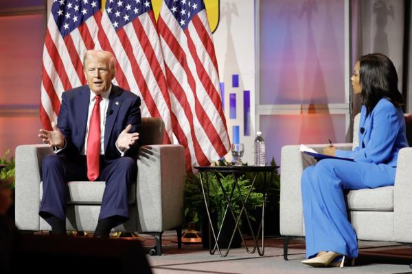 Trump, left, and Rachel Scott at the Natio<em></em>nal Black Journalists Association convention.