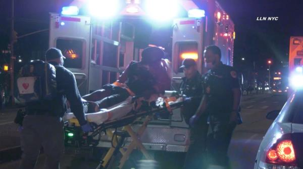 One of the victims of a Sunday morning shooting in Harlem being put in an ambulance.