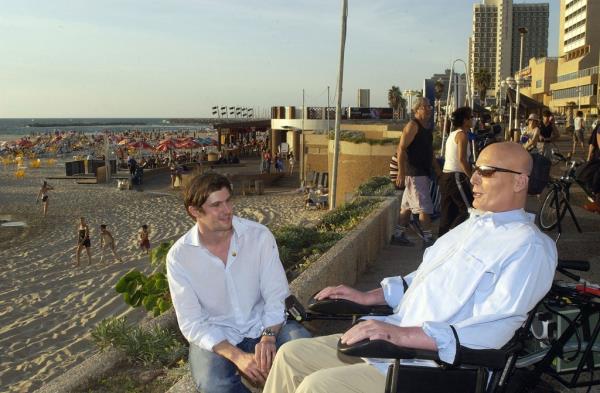 Christopher Reeve and Matthew Reeve talk on the promenade overlooking the Mediterranean Sea in Tel Aviv, Israel, in 2003. Christopher Reeve died a year later.