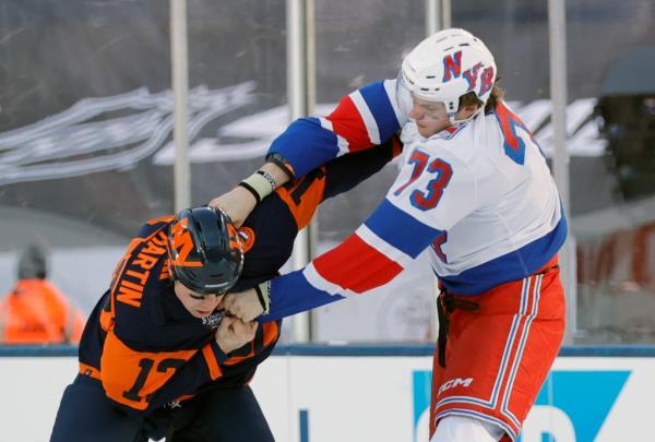 The Islanders' Matt Martin takes a punch from the Rangers' Matt Rempe on Sunday at MetLife Stadium.