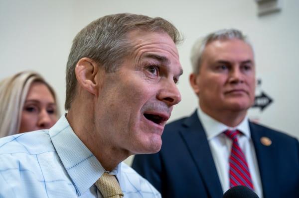 Jim Jordan, Marjorie Taylor Greene, and James Comer speaking to reporters in front of micropho<em></em>nes outside the Capitol building.