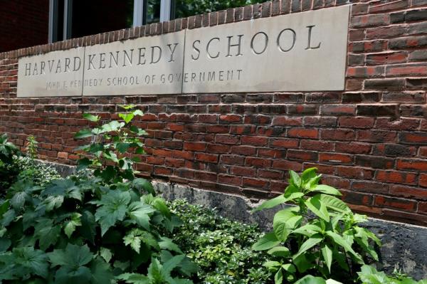 Harvard Kennedy School of Government sign on brick wall in Cambridge, Massachusetts.