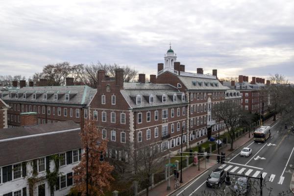 Harvard campus on John F. Kennedy Street, a large brick building with many windows.