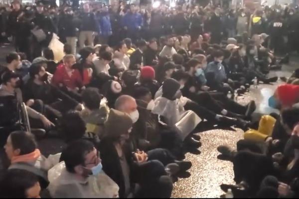 Protesters sitting across Fifth Avenue.