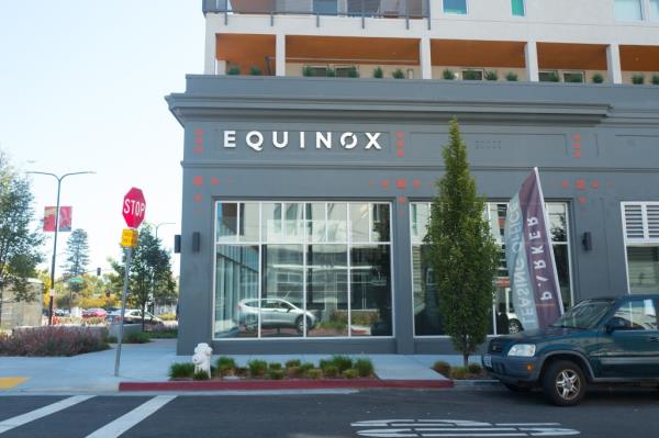 Sign on facade of the upscale Equinox gym in downtown Berkeley, California