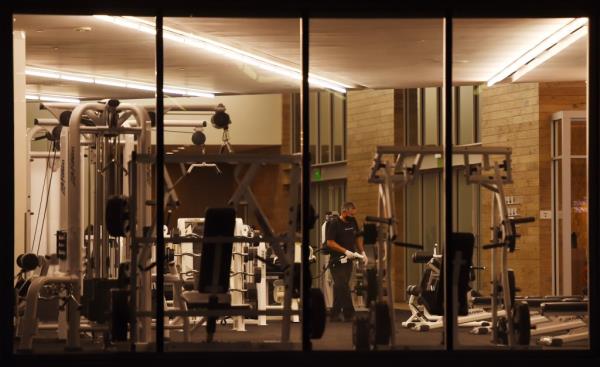 A cleaning staff member sanitizing gym equipment at Equinox in Marina del Rey, California amidst the Coro<em></em>navirus outbreak