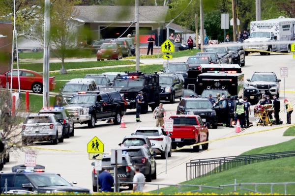 Law enforcement perso<em></em>nnel respo<em></em>nding to an active shooter report at Mount Horeb Middle School in Wisconsin, with police vehicles on the street