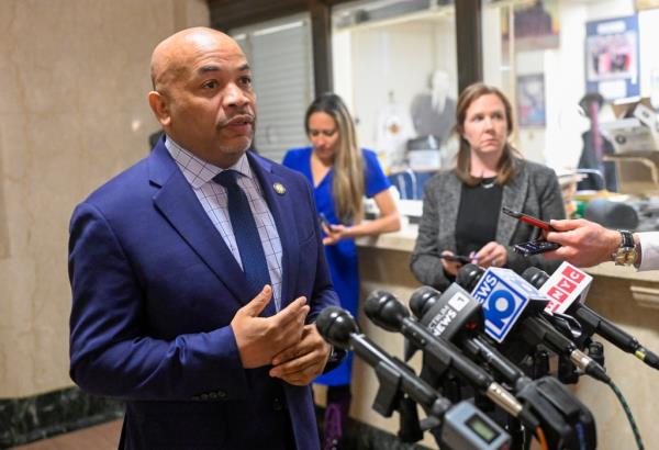 Assembly Speaker Carl Heastie speaking in front of microphones