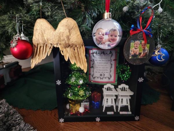 Snapshots of the twins' toothless grins, or of them playing in the grass, adorn ornaments hung from the Rodriguez's tree, while another shaped like angel wings hangs on a branch.