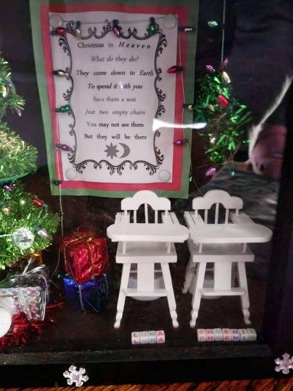 A box with two white high chair figurines inside, along with the message: “Christmas in Heaven/What do they do?/They come down to Earth/To spend it with you/Save them a seat/Just two empty chairs/You may not see them/But they will be there.”