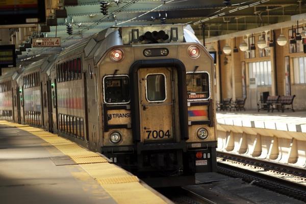  New Jersey Transit train pulling into a station.