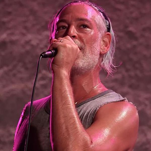 A close-up of Matisyahu singing into a microphone during a cancelled co<em></em>ncert due to safety co<em></em>ncerns and staff shortage at a venue in Southern Arizona.