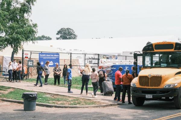 Migrants are dropped off to a pop up shelter on Wards Island