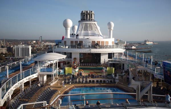 People sit and enjoy the facilites on the top deck o<em></em>nboard the cruise ship Quantum of the Seas.