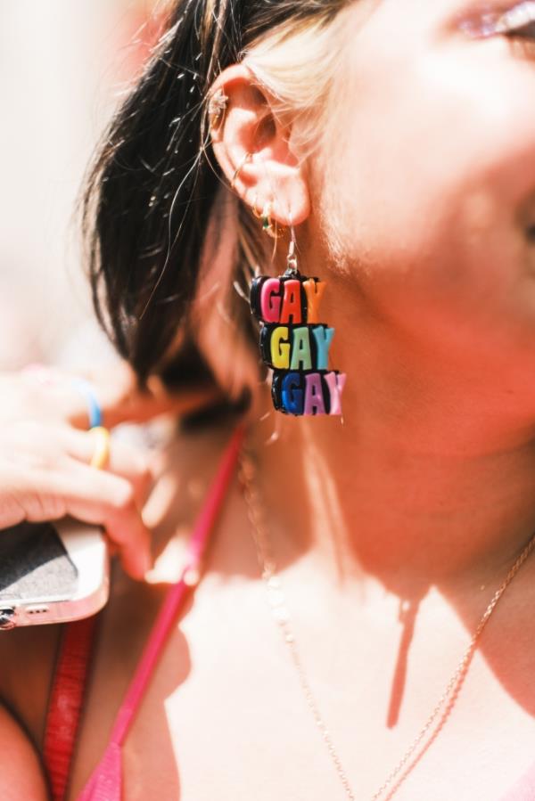 A woman's earrings that say, 