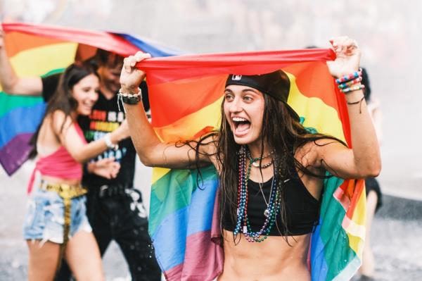 A woman with a rainbow flag around her head. 