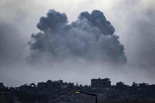 A cloud of smoke and dust rises from the ruins of Gaza on Thursday, as Israeli forces press the attack before a ceasefire