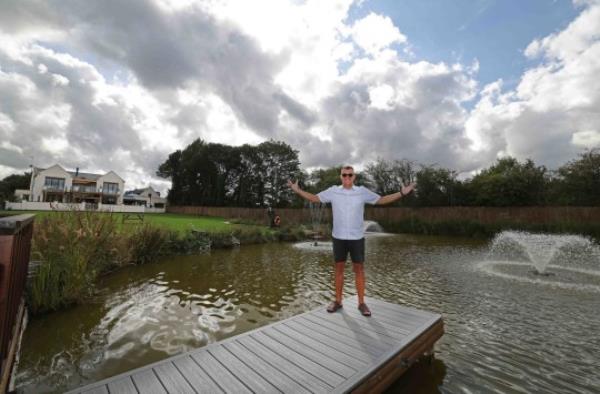 EMBARGOED TO 0001 WEDNESDAY SEPTEMBER 27 Undated handout photo issued by EuroMillions of Gareth Bull at his new home. The EuroMillions jackpot winner said building his 6,000 sq ft dream house with an artificial lake filled with rehomed fish and an accompanying lodge helped him get through the Covid-19 lockdown. Mr Bull, 52, won the EuroMillions jackpot of ?40,627,241 in January 2012 and four years ago he started building his dream house. The completed four-bedroom house features a swimming pool with programmable waves, a sound system built into the ceilings, three bars and two hot tubs. Issue date: Wednesday September 27, 2023. PA Photo. See PA story SOCIAL EuroMillions. Photo credit should read: Gareth Jones/EuroMillions/PA Wire NOTE TO EDITORS: This handout photo may o<em></em>nly be used in for editorial reporting purposes for the co<em></em>ntemporaneous illustration of events, things or the people in the image or facts mentio<em></em>ned in the caption. Reuse of the picture may require further permission from the copyright holder.