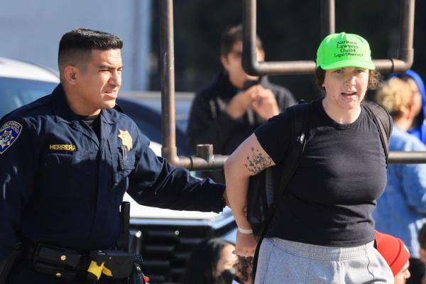 A protester being led away by police. 