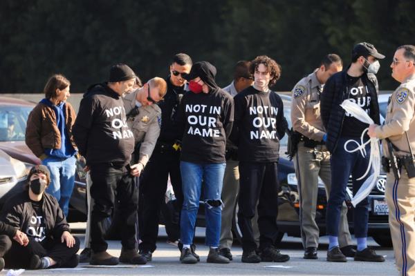 A line of protesters being detained. 