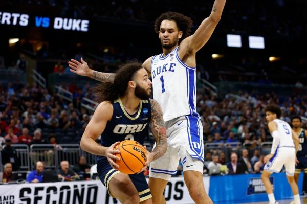 Kareem Thompson #2 of the Oral Roberts Golden Eagles controls the ball against Dereck Lively II #1 of the Duke Blue Devils