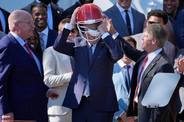 Biden initially attempted to put the helmet on overtop of his sunglasses.