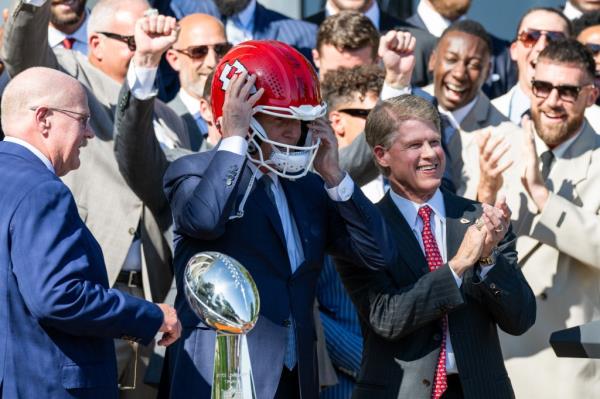 Kelce, right, applauded and laughed during Biden's photo op.