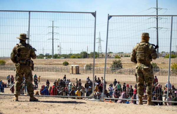 Texas Natio<em></em>nal Guard patrol the southern border in El Paso, Texas as migrants amass along a fence.