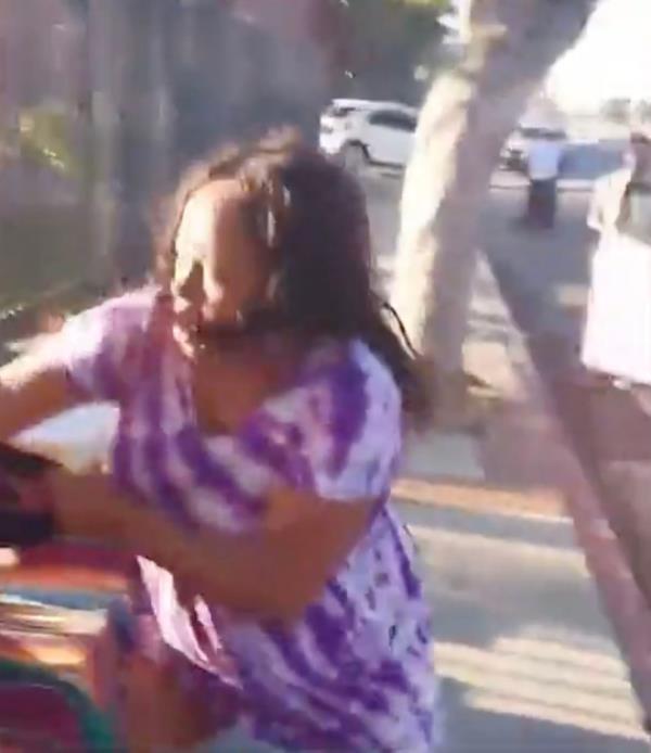 Screenshot from a cellphone video shows a woman beating up a taco vendor in Los Angeles 