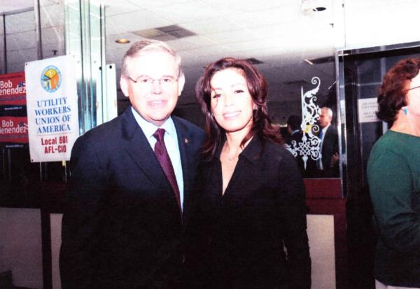 Senator Bob Menendez and married lover Cecilia Reynolds in front of a campaign sign and a unio<em></em>n sign.