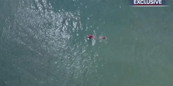 A lifeguard swam out to meet a boogie boarder who appeared to have drifted too far from shore in Flagler Beach, Florida, over the weekend.